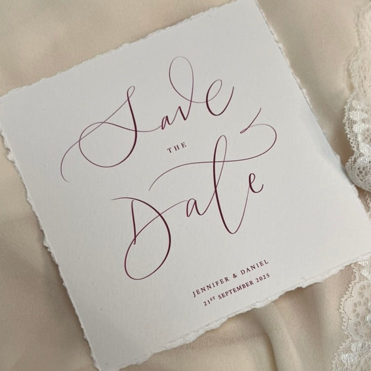 close up of calligraphy wedding save the date card, soft white card with berry ink