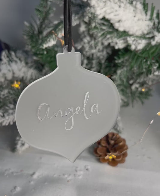 Video of hanging bauble handwritten name catching light