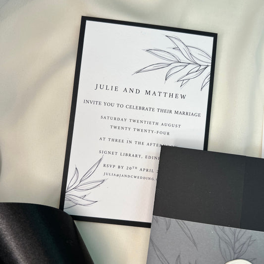 flat wedding invite black and white with drawing of foliage