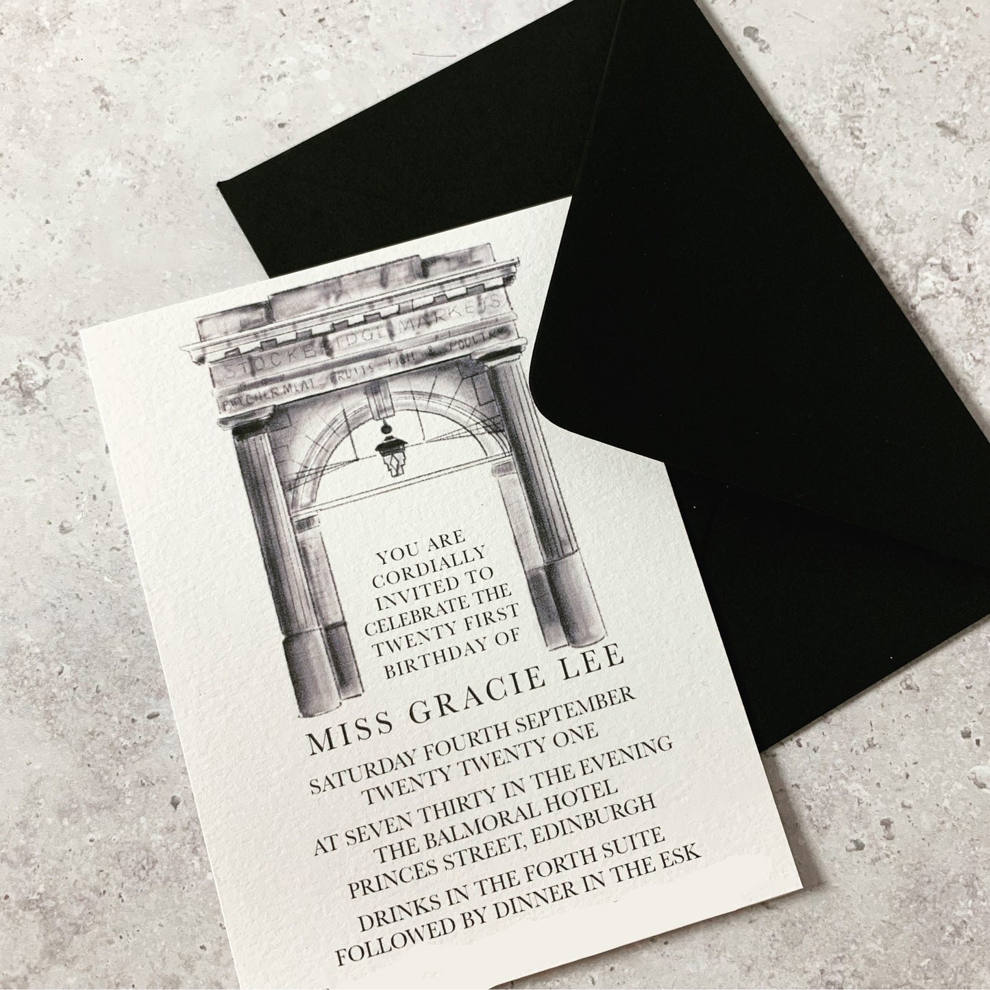 Elegant bespoke black and white party invitation featuring intricate designs, perfect for a memorable party. The drawing above the large, blocky text is of Stockbridge market and is extremely detailed.