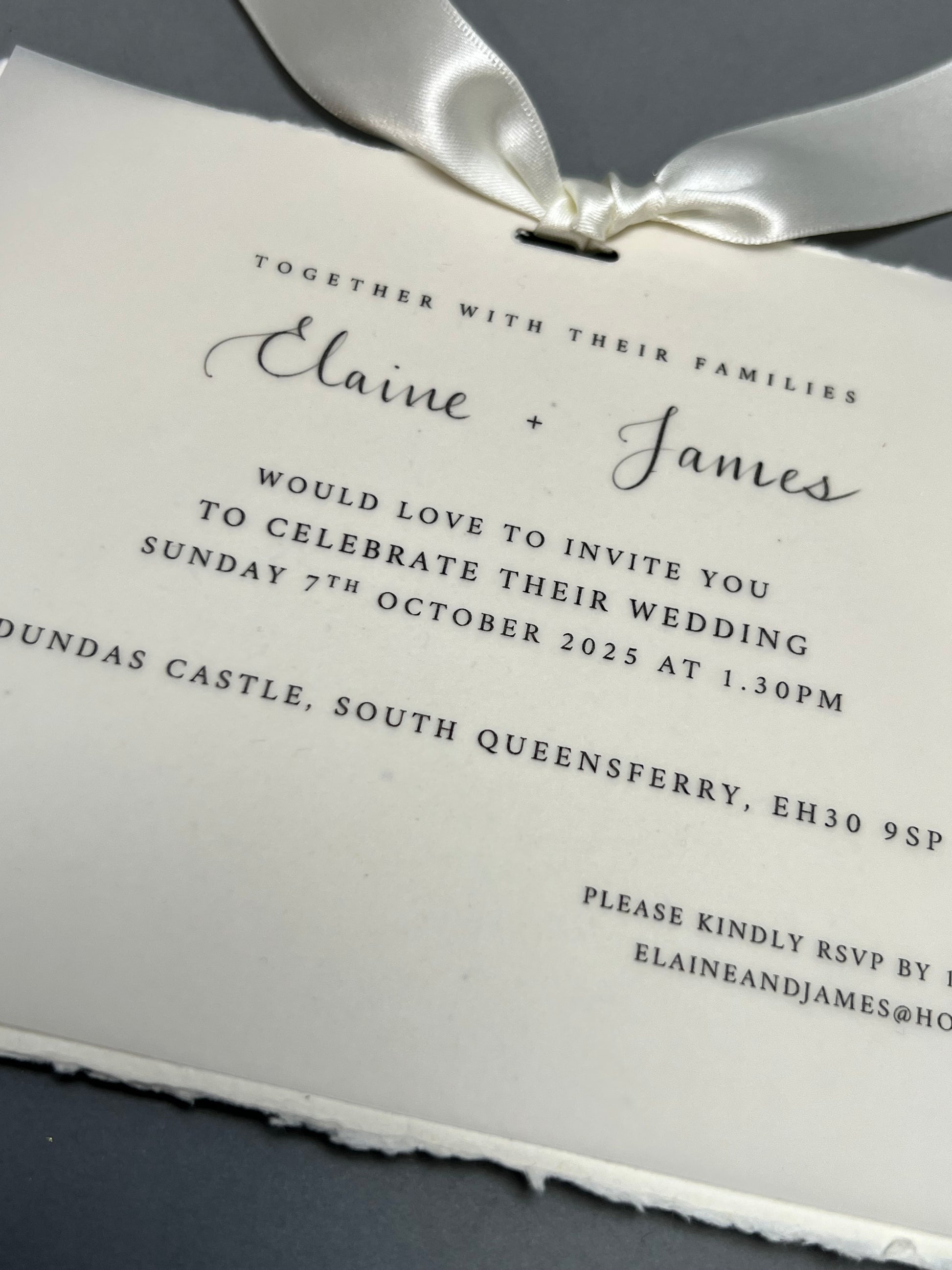 close up wedding invitation vellum paper and cotton paper with calligraphy