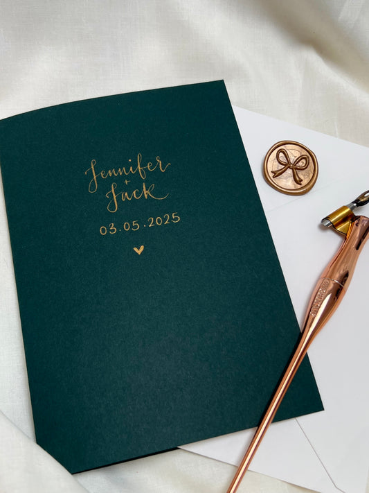Dark green personalised wedding card with gold ink calligraphy and gold bow wax seal 