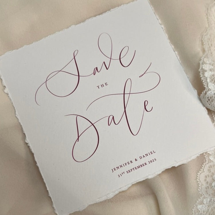 close up of calligraphy wedding save the date card, soft white card with berry ink 