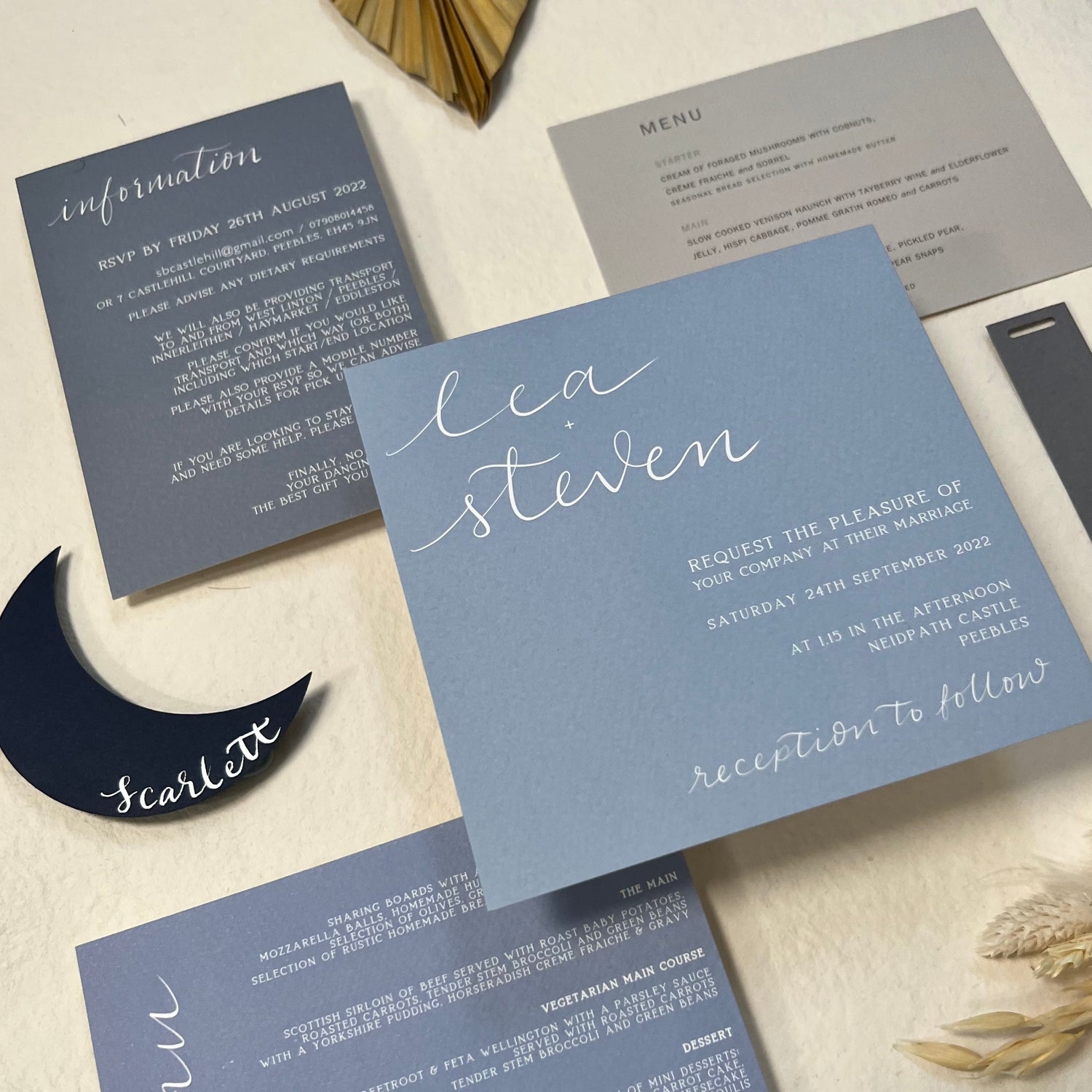 Blue range of wedding invites, menus, moon place card, information cards