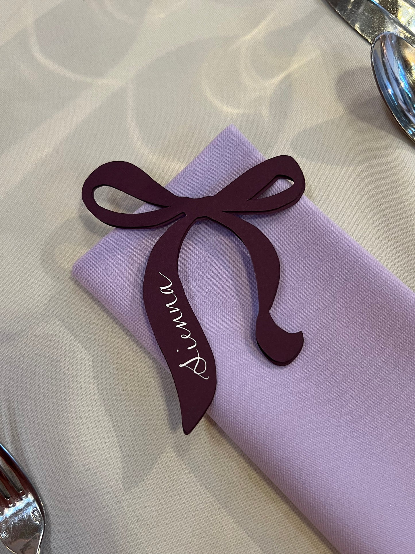 Bow Calligraphy Place card on a napkin 
