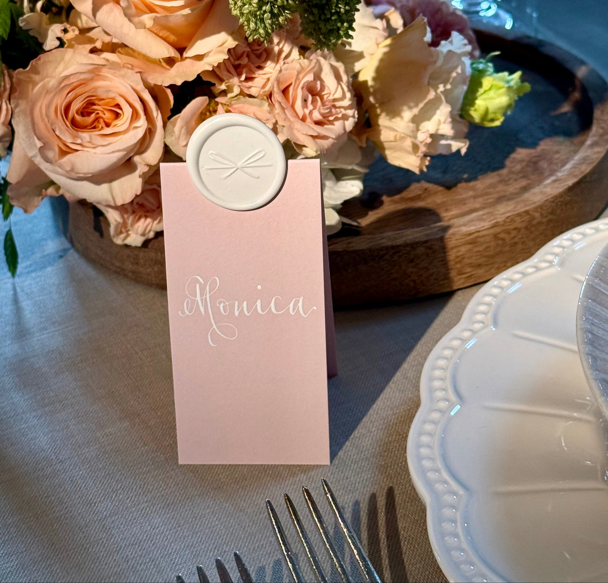 Floral arrangement with a pink name tag on a table setting