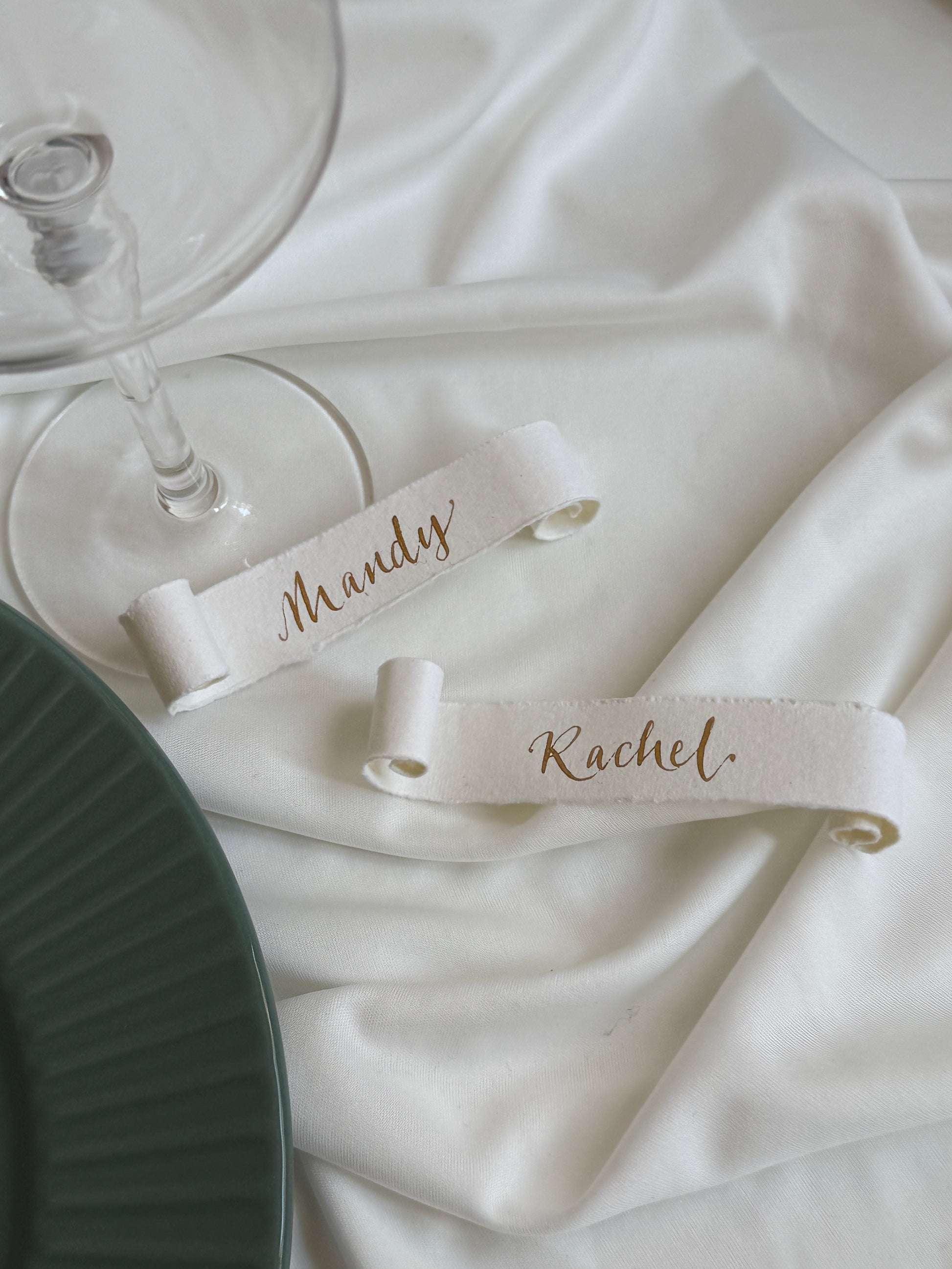 Soft white cotton paper scrolls with gold ink calligraphy names handwritten