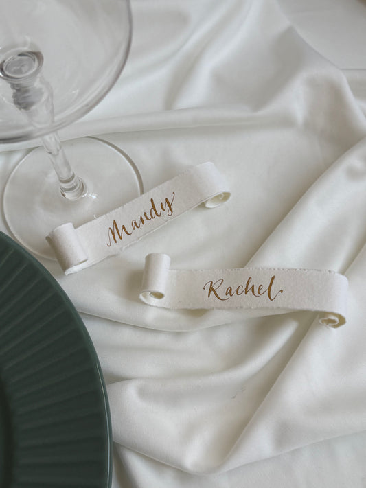 Soft white cotton paper scrolls with gold ink calligraphy names handwritten