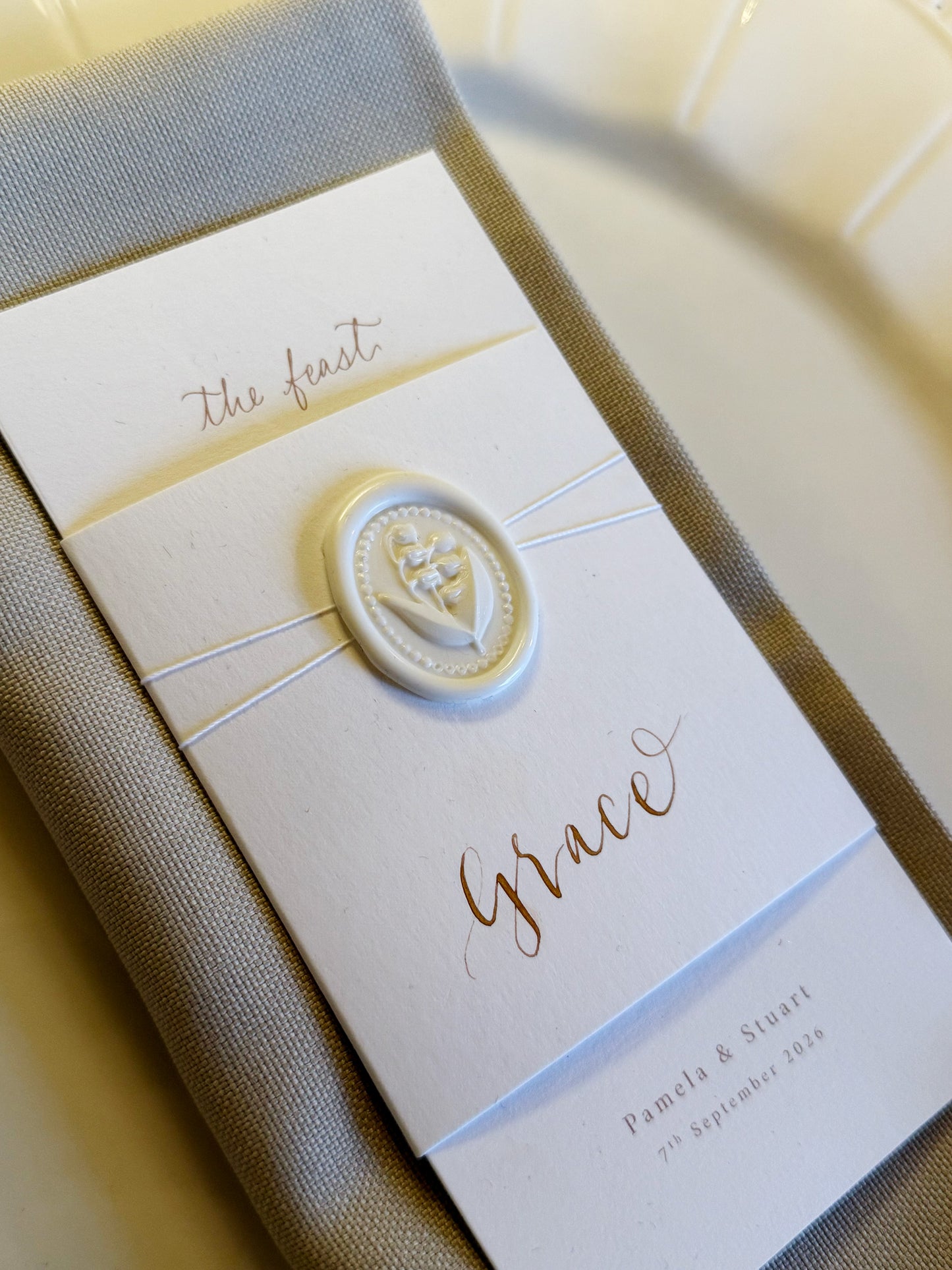 Decorative menu with 'The feast' and 'Grace' text, featuring a decorative emblem.