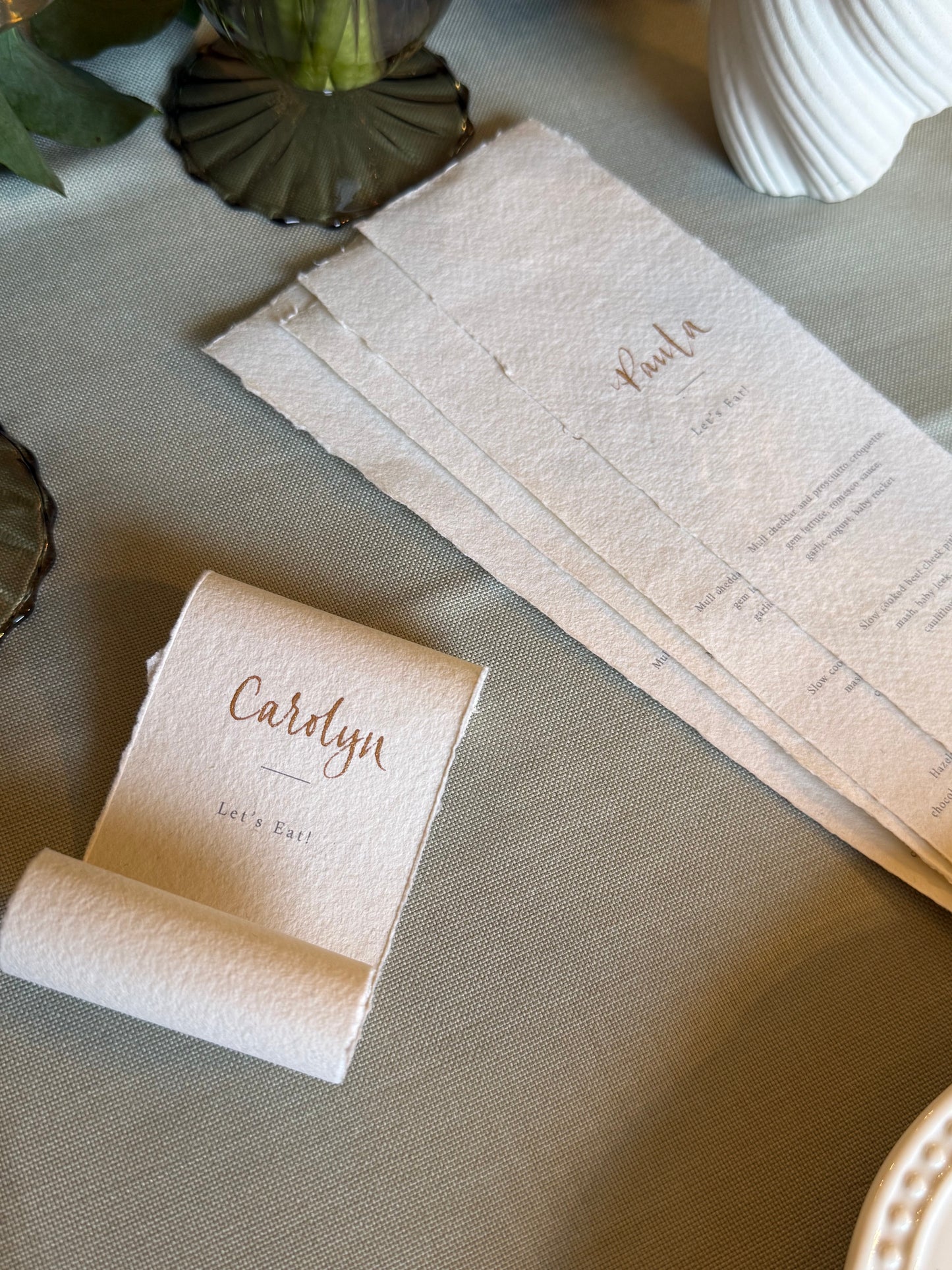 place card scrolls, soft cotton paper with handwritten guest name and printed menu hidden in scroll