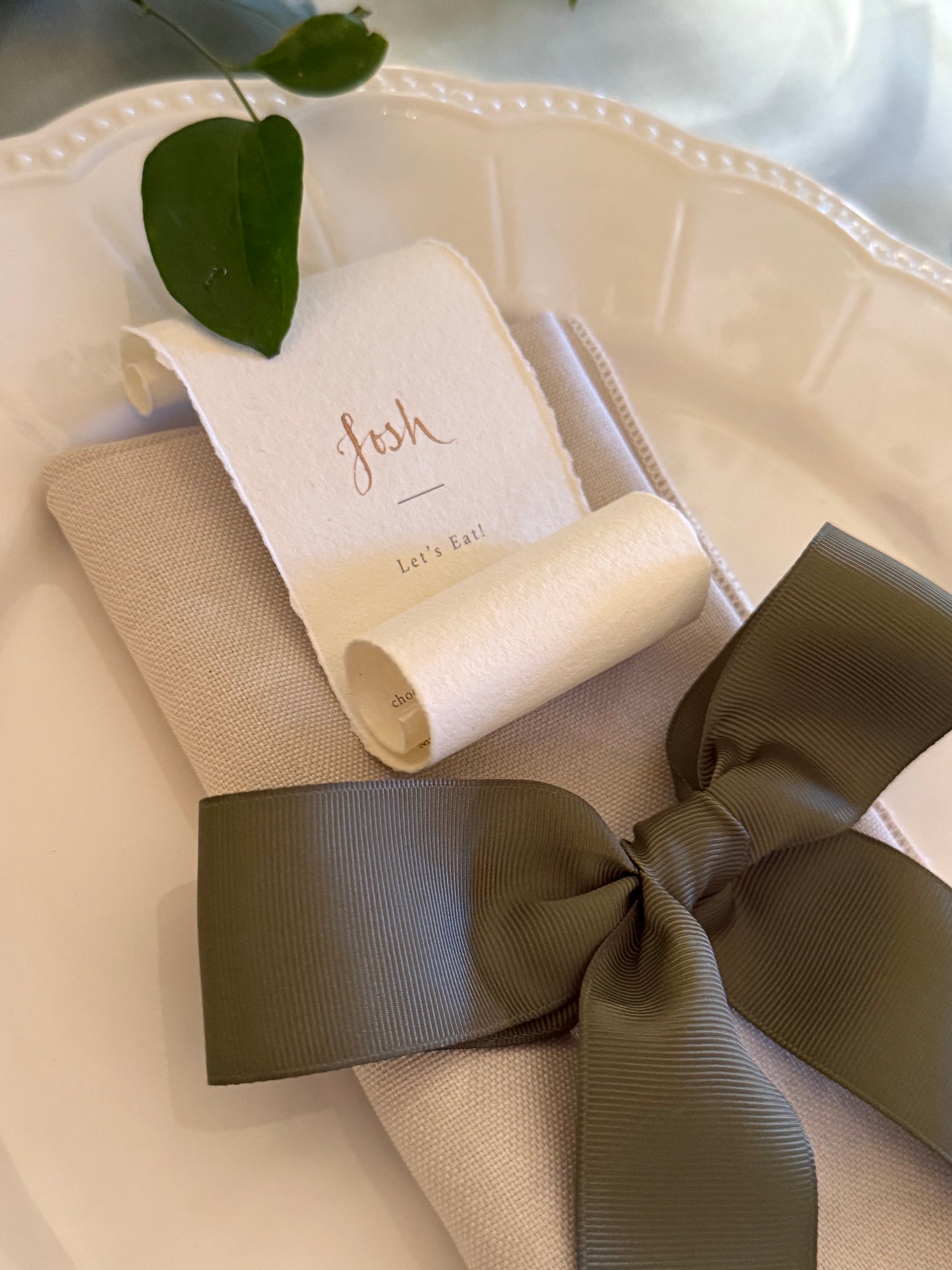 torn edge handmade cotton paper with guest name in gold ink calligraphy, menu printed below to reveal with unravelled.