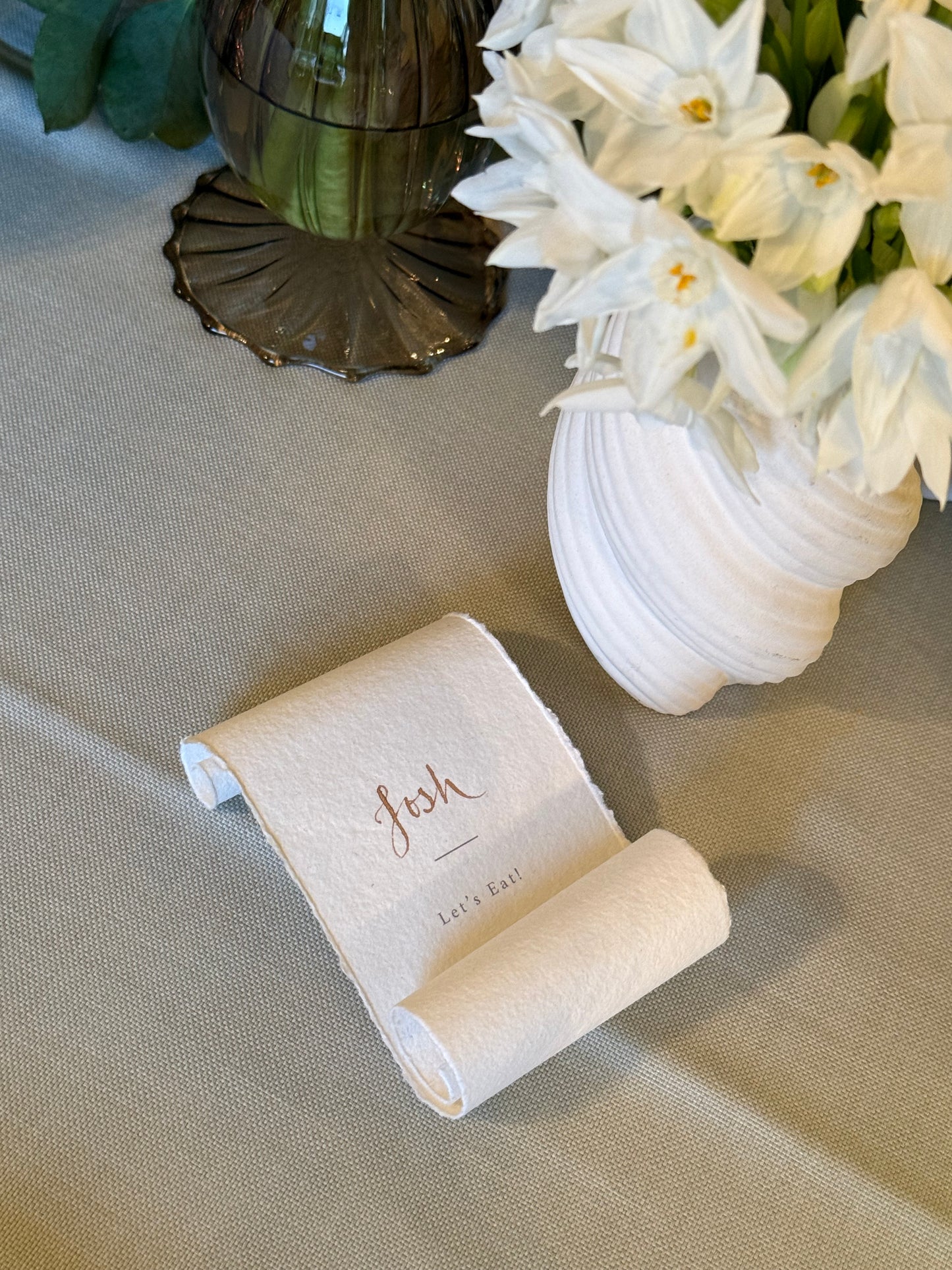 Paper scroll place card with menu reveal. guest name in gold ink calligraphy 