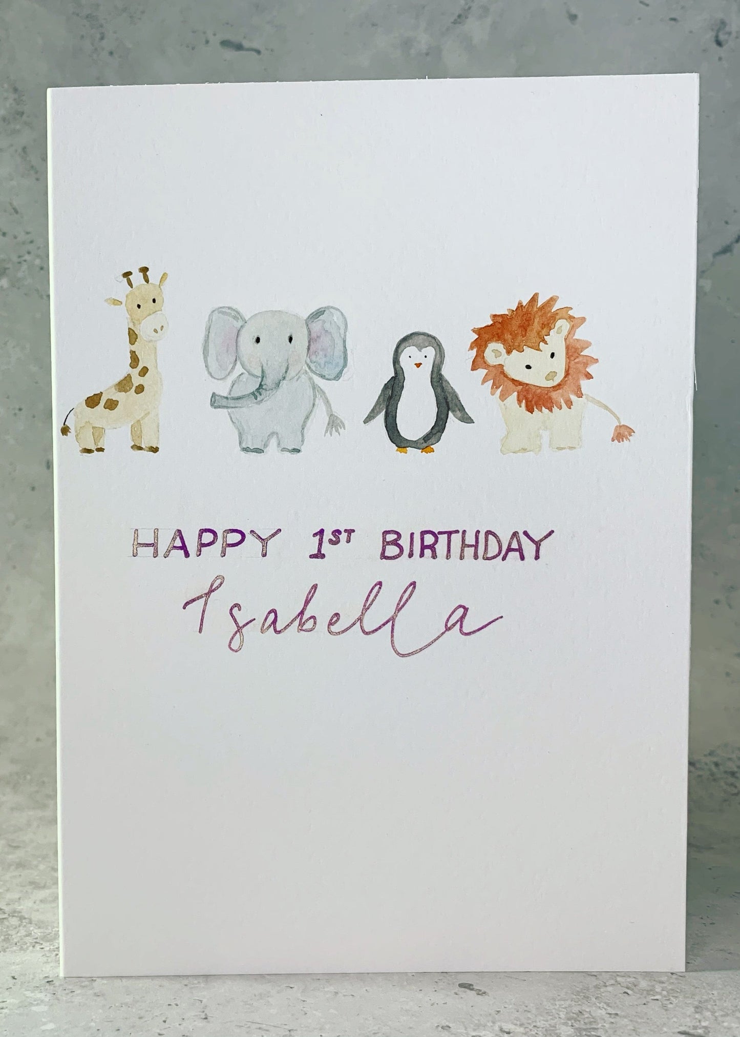 A personalized, bespoke birthday card featuring a giraffe, elephant, lion, and penguin in a colourful design, perfect for celebrating a special day.