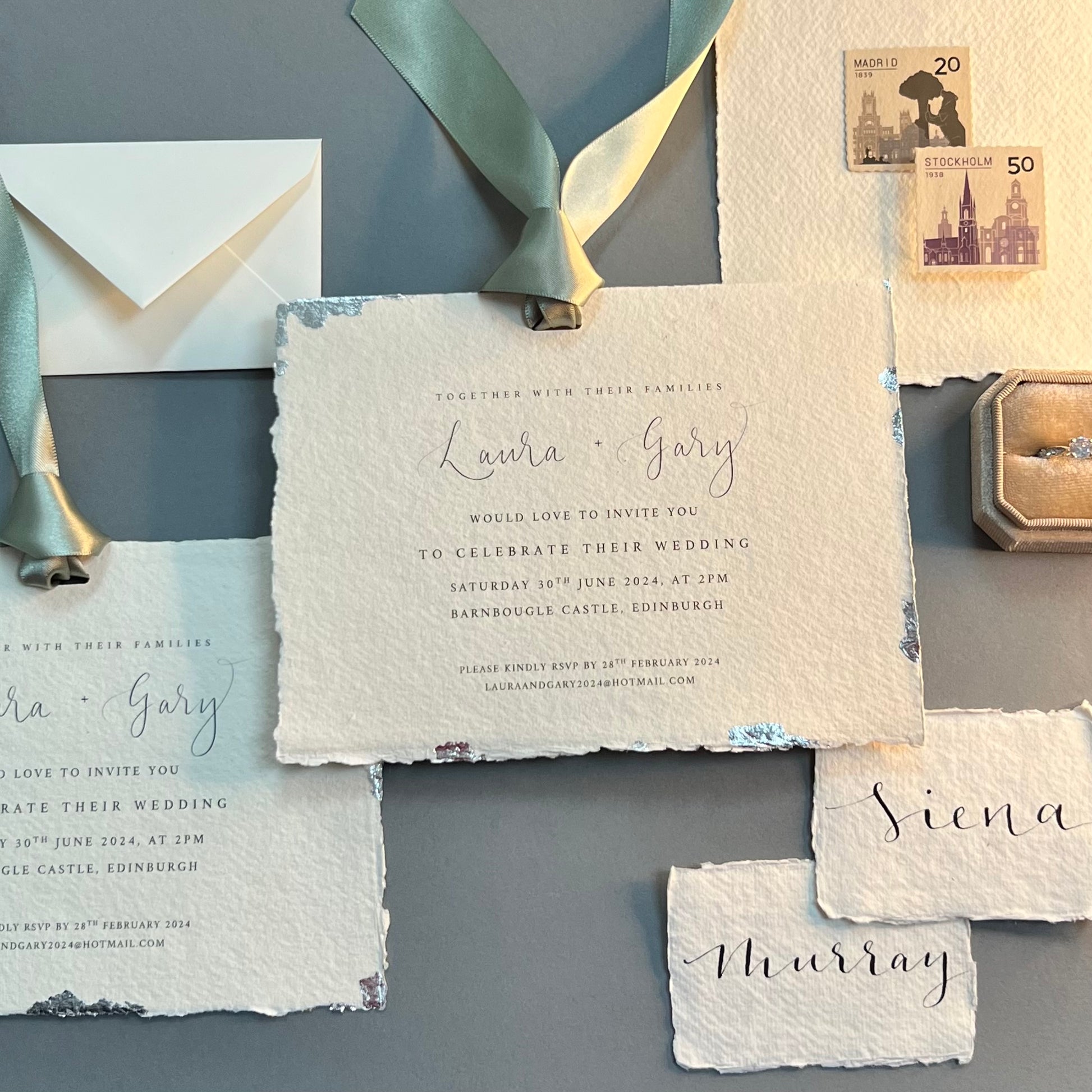 Collection of cotton paper invites, envelopes, stamps and wedding ring
