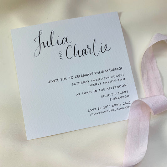 Calligraphy invite in white card with pink ribbon