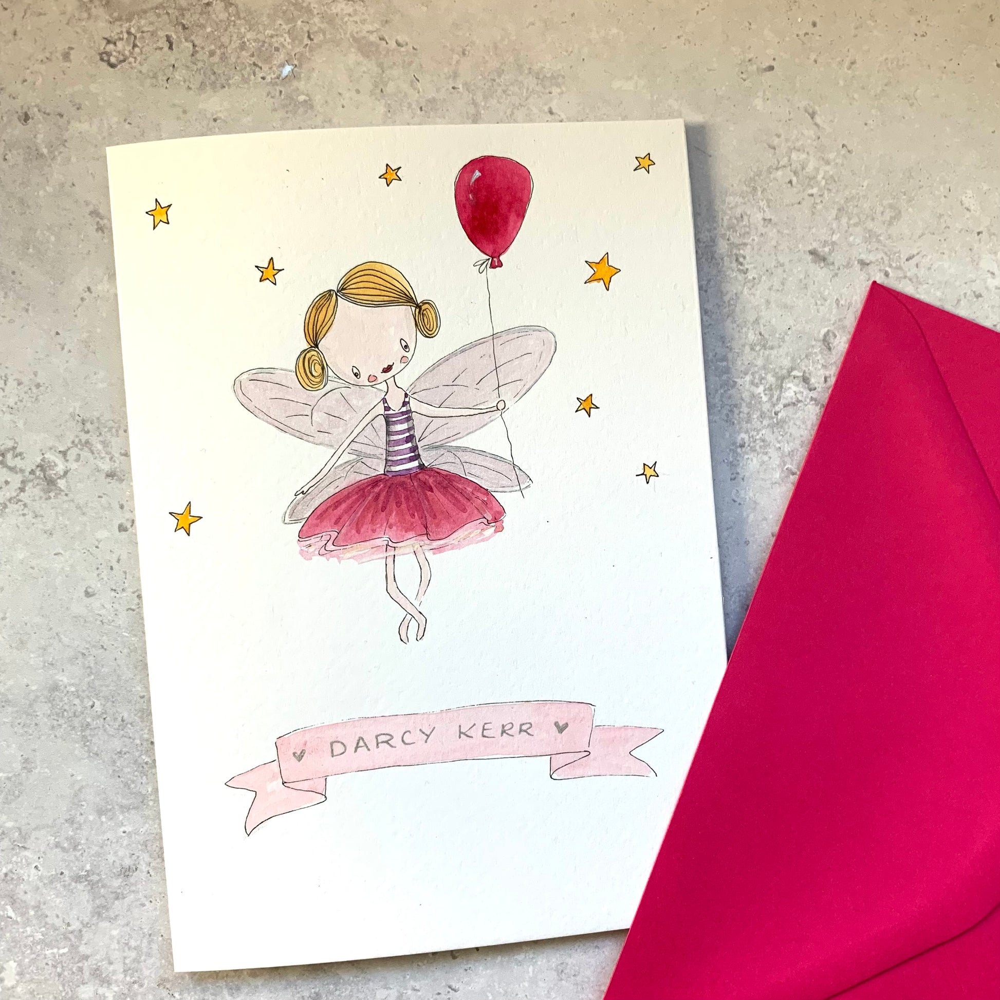 A whimsical hand illustrated card featuring a fairy holding a bright red balloon, set against a soft, enchanting background.