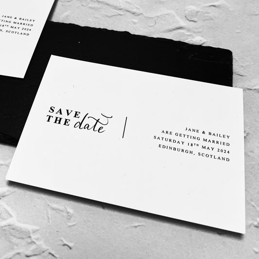 White card on black background, printed with save the date. Modern New York Style