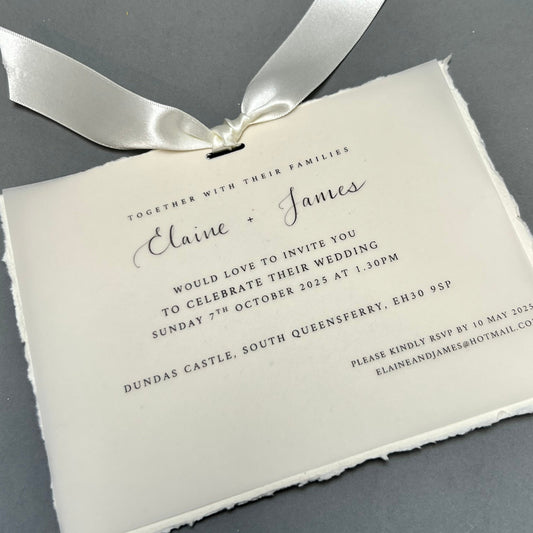 cotton paper with soft uneven edges and sharp cut vellum tied together with ivory ribbon