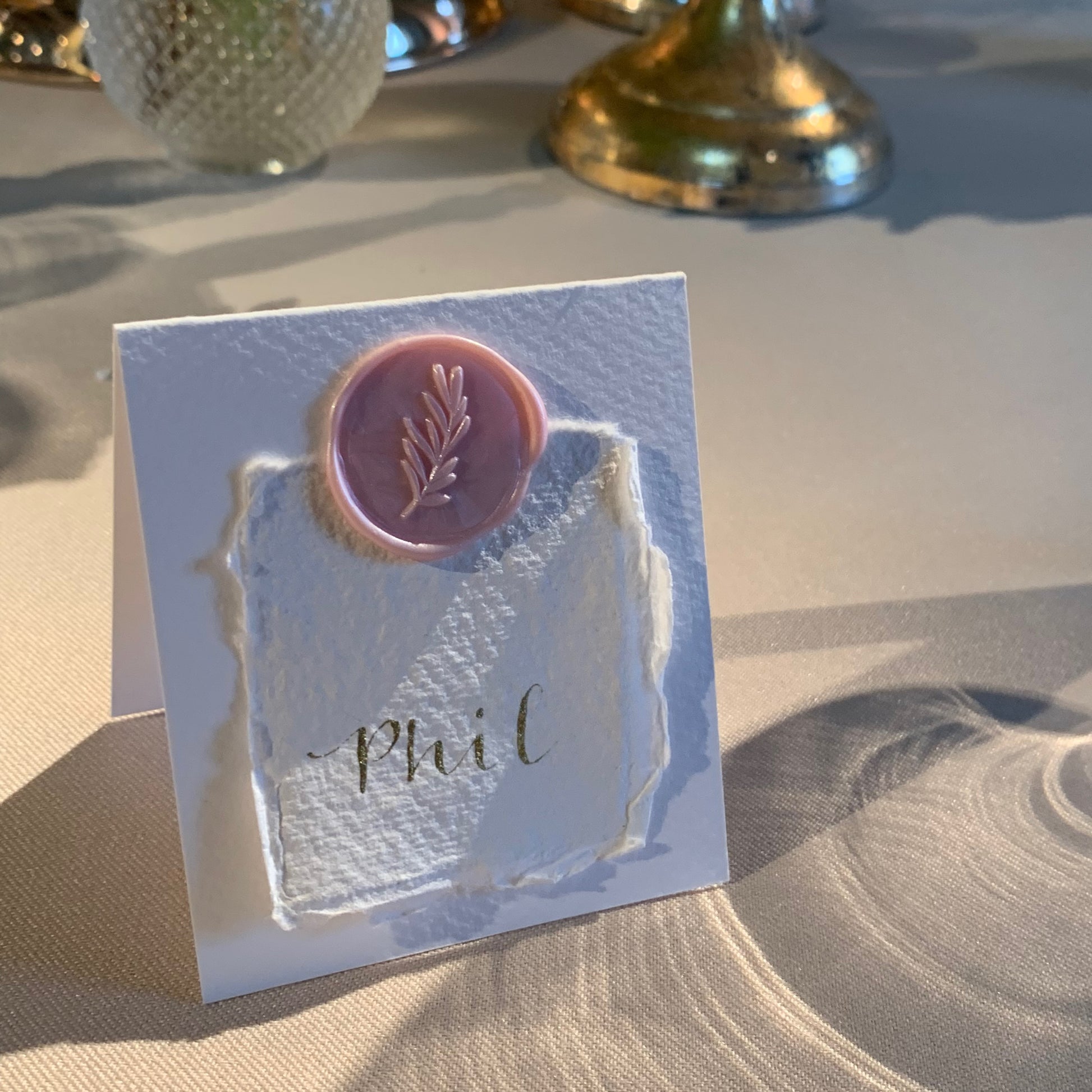 folded place card in white card with pale pink wax seal holding smaller cotton paper with guest name wedding calligraphy 
