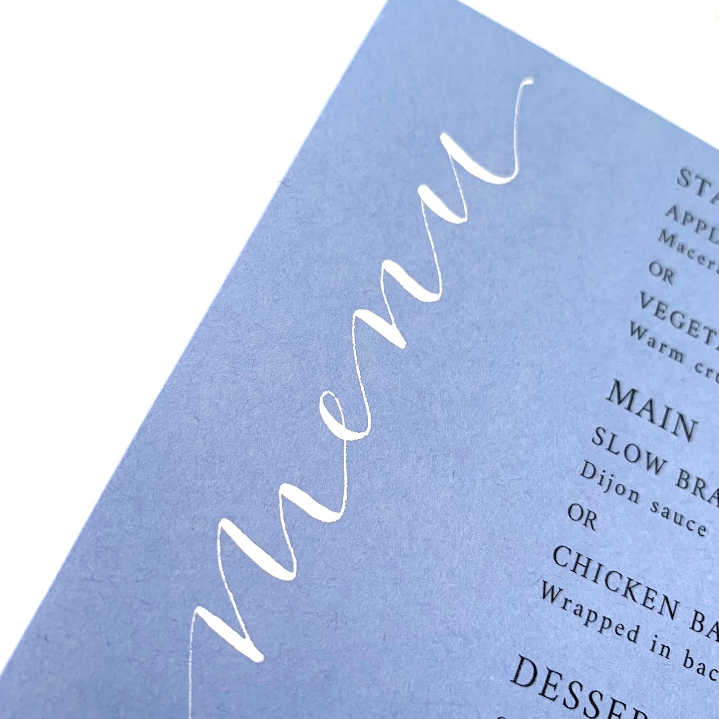 Powder blue menu with white ink calligraphy