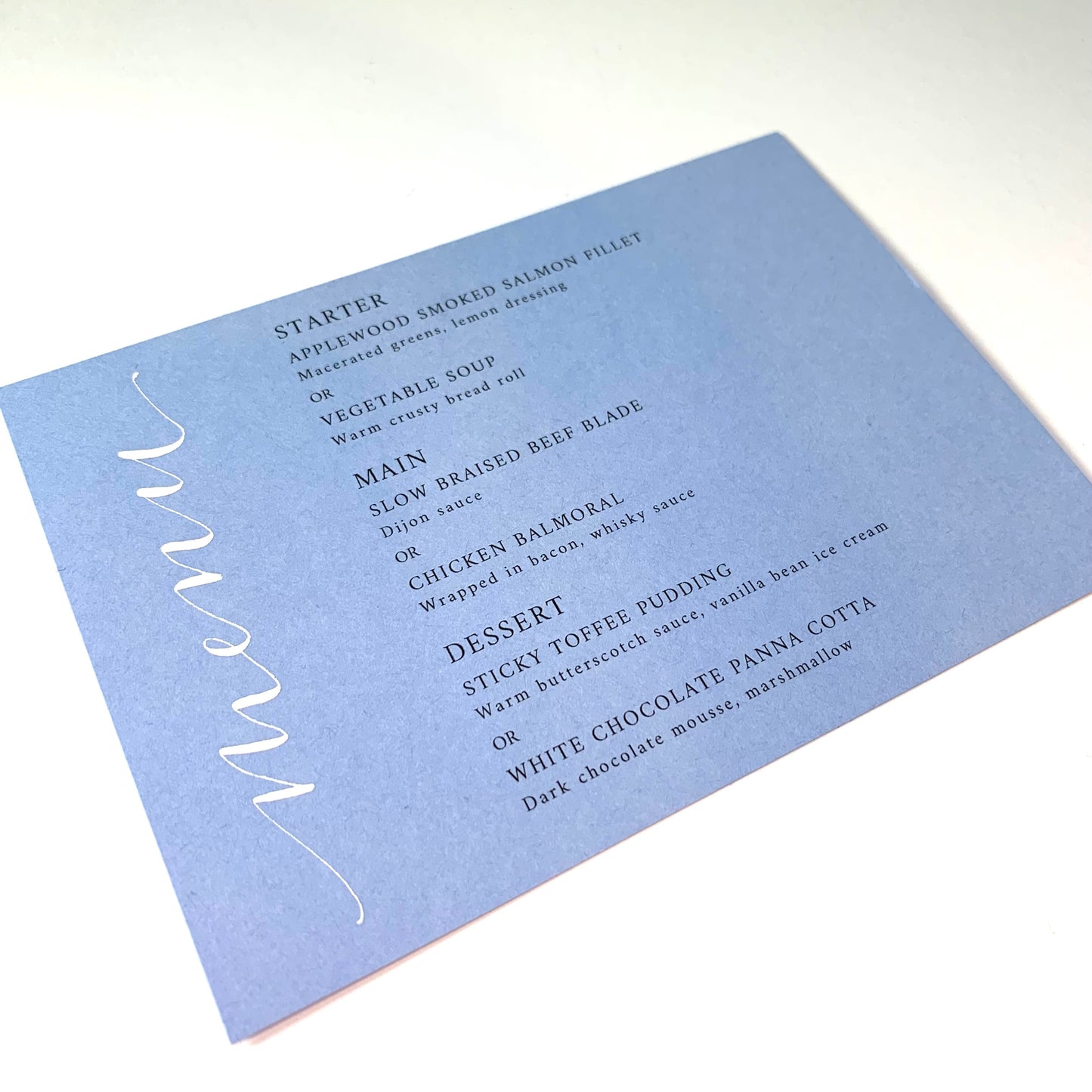 Powder blue menu with white ink calligraphy