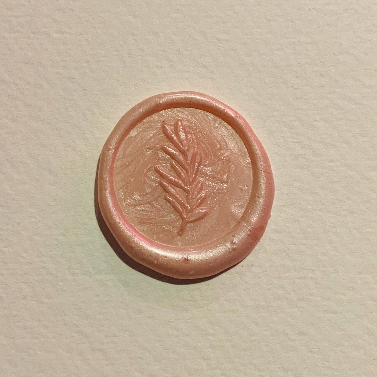 pale pink, pearly wax seal with foliage design