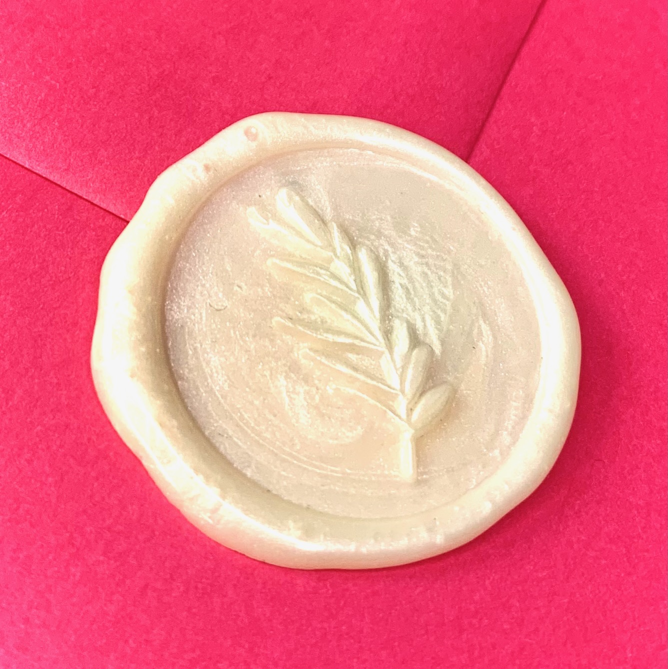 white wax seal with foliage design